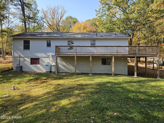 back of house featuring a yard, central AC, and a wooden deck