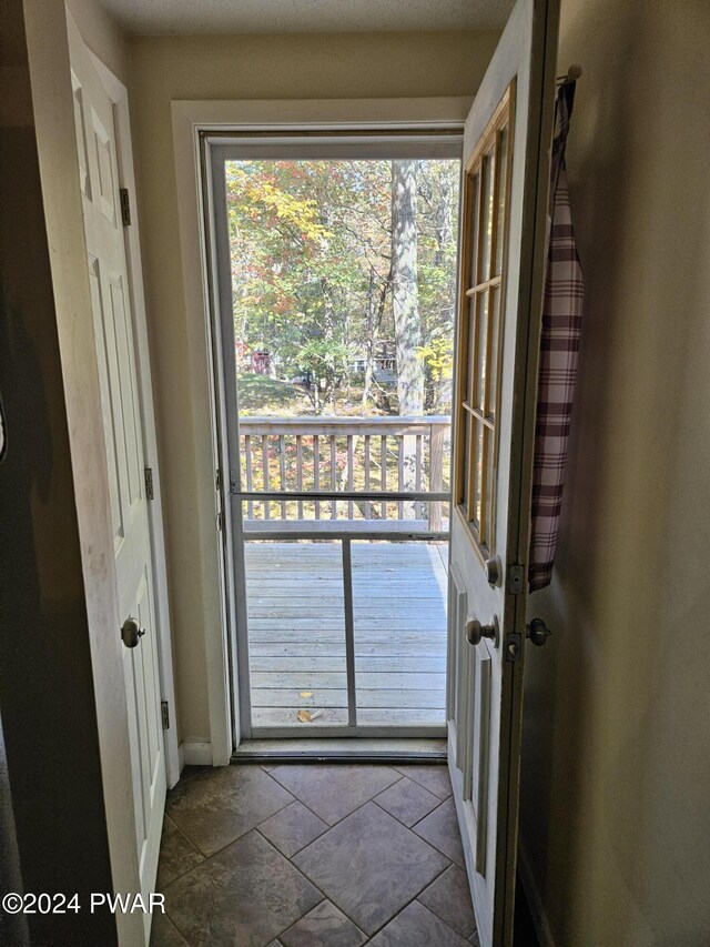 doorway to outside featuring tile patterned flooring