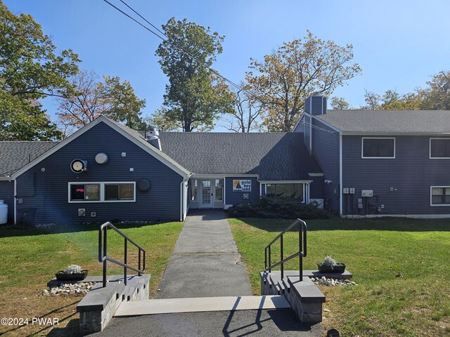 view of front of house with a front yard, french doors, and central AC