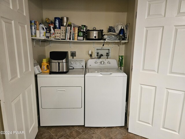 laundry room featuring dark tile patterned floors and washer and clothes dryer