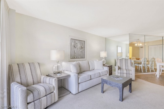 living room with light carpet and ceiling fan