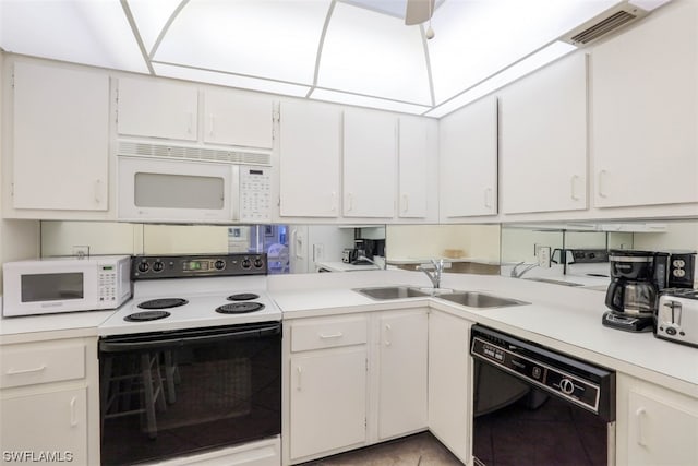 kitchen featuring white appliances, ceiling fan, white cabinetry, and sink