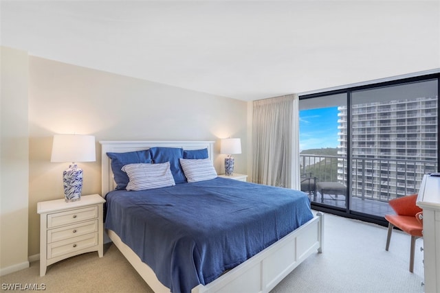 bedroom featuring light colored carpet, access to exterior, and floor to ceiling windows