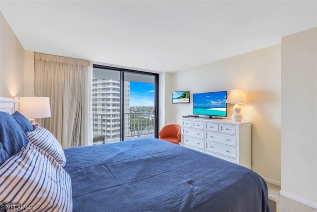 bedroom featuring carpet, access to exterior, and floor to ceiling windows