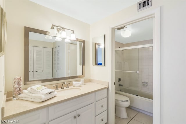 full bathroom featuring combined bath / shower with glass door, toilet, tile floors, and oversized vanity