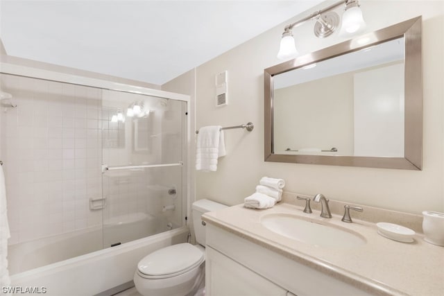 full bathroom with vanity, enclosed tub / shower combo, and toilet