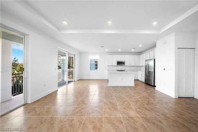 kitchen with open floor plan, recessed lighting, appliances with stainless steel finishes, and light countertops