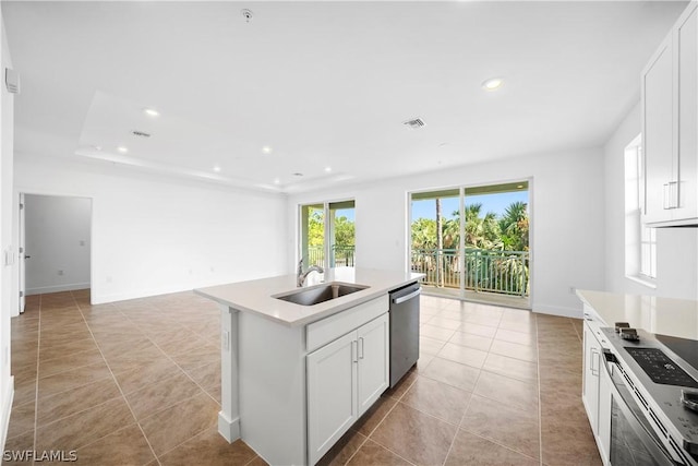 kitchen with recessed lighting, stainless steel appliances, a sink, white cabinetry, and open floor plan