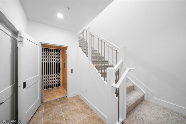 staircase with tile patterned flooring, recessed lighting, and baseboards