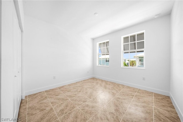 tiled empty room with baseboards