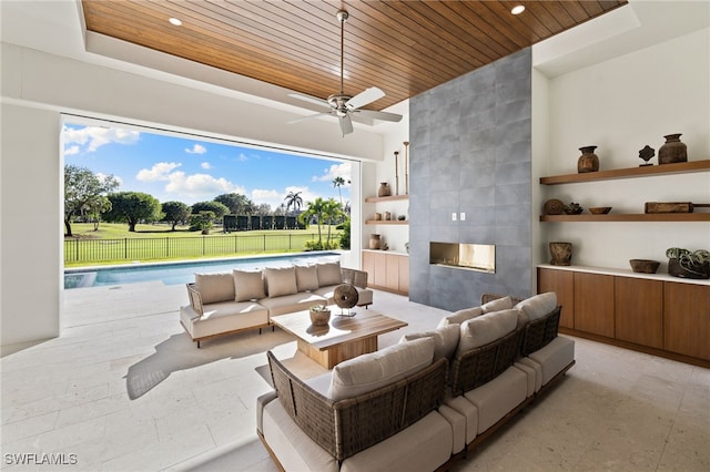 view of patio featuring an outdoor pool, fence, an outdoor living space with a fireplace, and ceiling fan