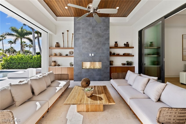 living room featuring wooden ceiling, a tray ceiling, built in shelves, a fireplace, and recessed lighting