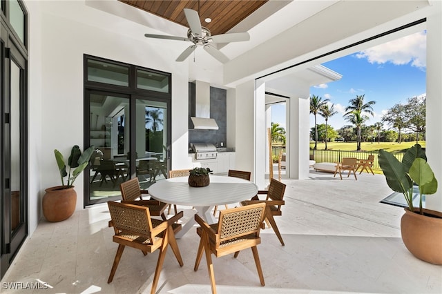 view of patio / terrace featuring ceiling fan, outdoor dining area, a grill, exterior kitchen, and french doors