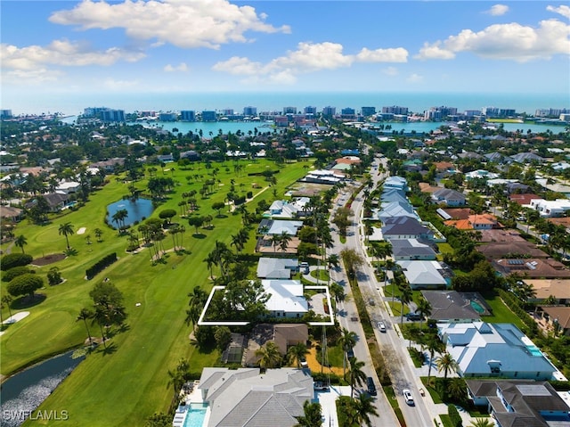 aerial view with golf course view, a water view, and a city view