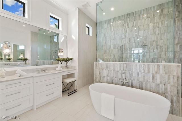 bathroom with a walk in shower, a freestanding bath, and tile walls