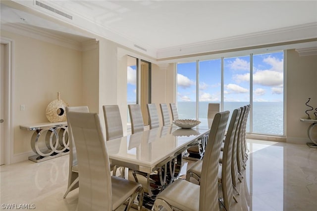 dining area featuring ornamental molding, a water view, visible vents, and baseboards