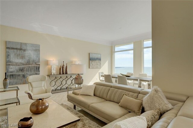 living room featuring a water view and ornamental molding