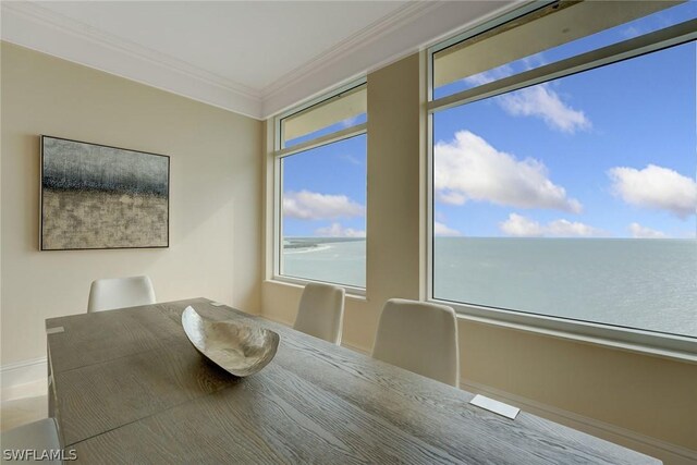 unfurnished dining area featuring ornamental molding and a water view