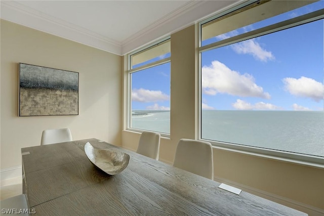 unfurnished dining area featuring a water view and crown molding