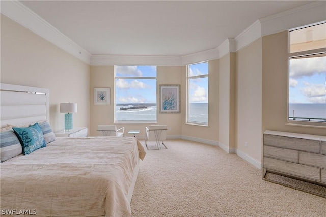 carpeted bedroom with ornamental molding and baseboards