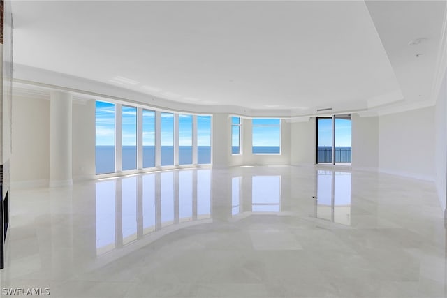 unfurnished room with light tile patterned flooring, a water view, crown molding, and floor to ceiling windows