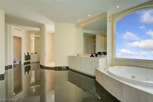 full bath featuring recessed lighting, vanity, and a tub with jets