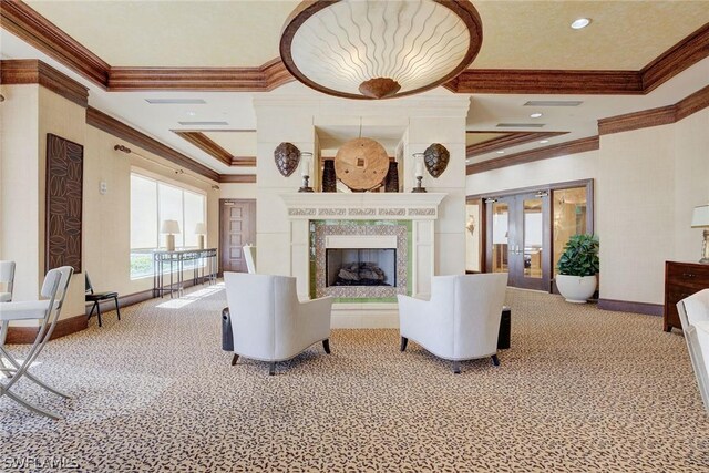 unfurnished living room featuring ornamental molding, carpet flooring, a fireplace, and french doors