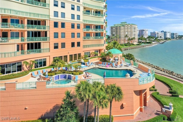 view of pool featuring a water view and a city view