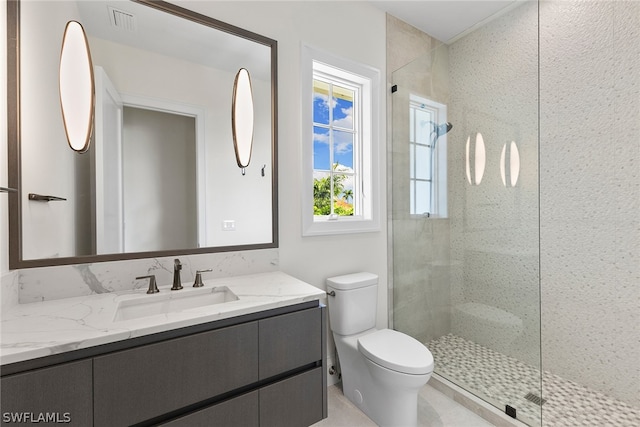 bathroom with a shower with door, toilet, and large vanity