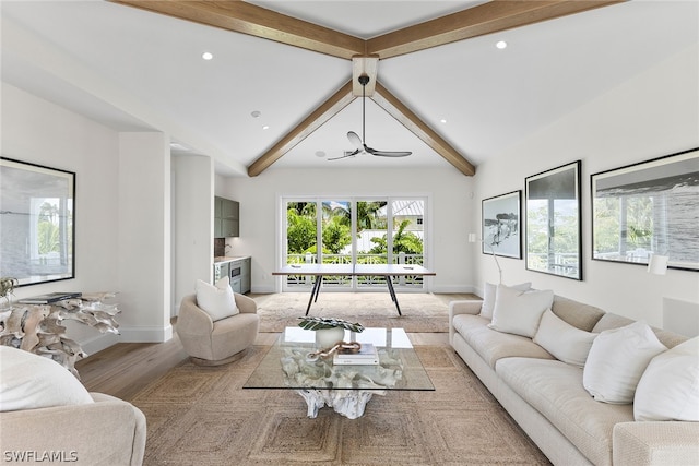 living room featuring wood-type flooring and vaulted ceiling with beams