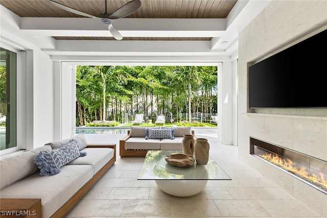 living room with a healthy amount of sunlight, wooden ceiling, and a fireplace