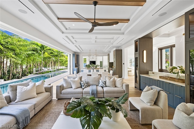 interior space featuring coffered ceiling, beamed ceiling, and ceiling fan