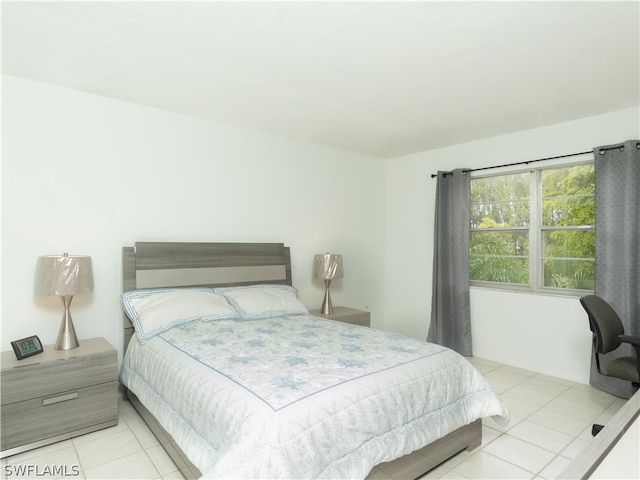 bedroom with light tile patterned floors