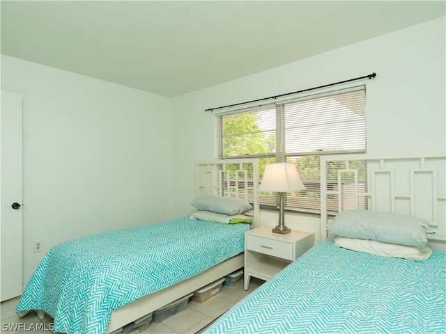 bedroom with light tile patterned floors