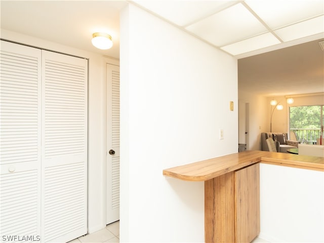 kitchen with kitchen peninsula and light tile patterned flooring