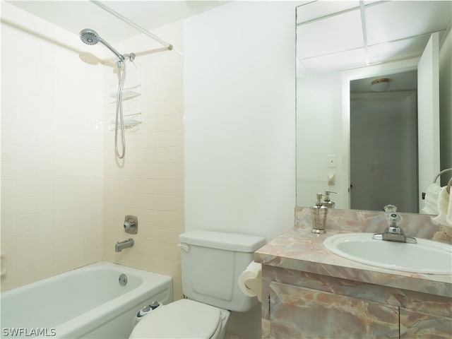 full bathroom featuring tiled shower / bath combo, vanity, and toilet