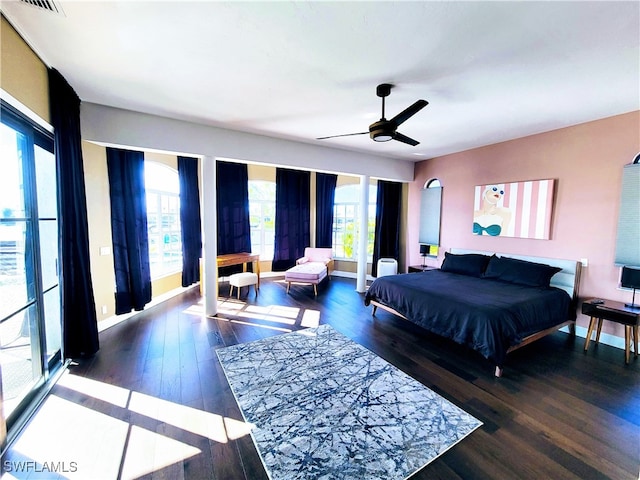 bedroom with ceiling fan and dark hardwood / wood-style floors