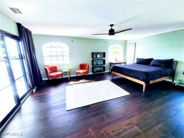 bedroom with ceiling fan and dark hardwood / wood-style floors