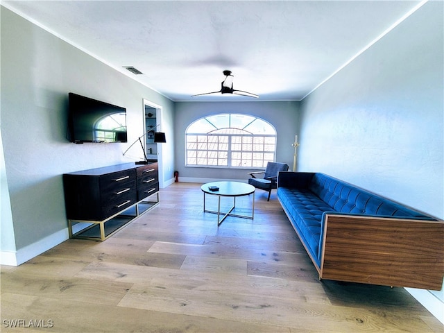 living room featuring light hardwood / wood-style floors and ceiling fan