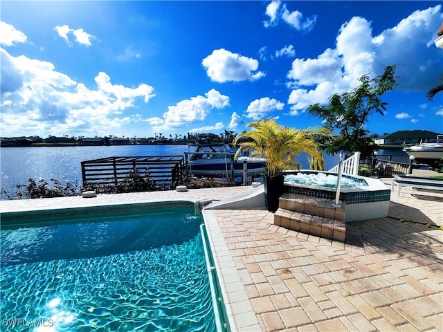 view of swimming pool featuring a water view and a patio area