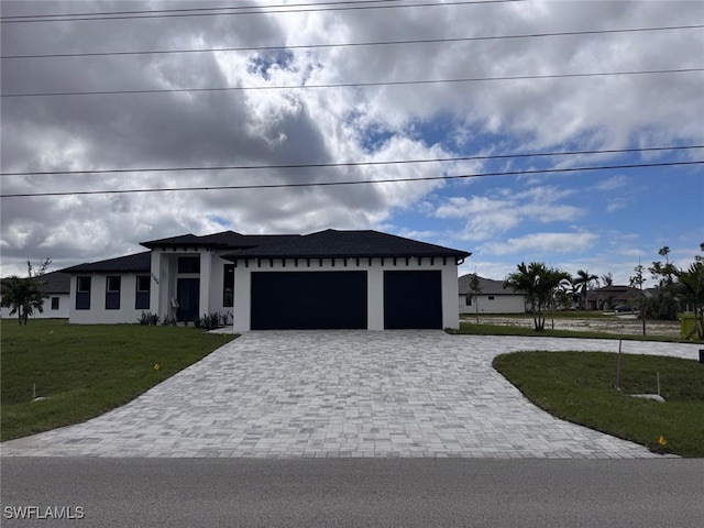 prairie-style house with stucco siding, an attached garage, decorative driveway, and a front lawn