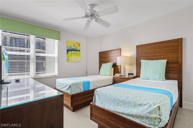 bedroom with ceiling fan and light carpet