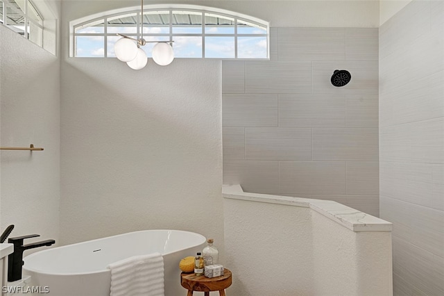 bathroom featuring shower with separate bathtub