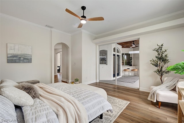 bedroom with access to outside, hardwood / wood-style flooring, ceiling fan, and ornamental molding