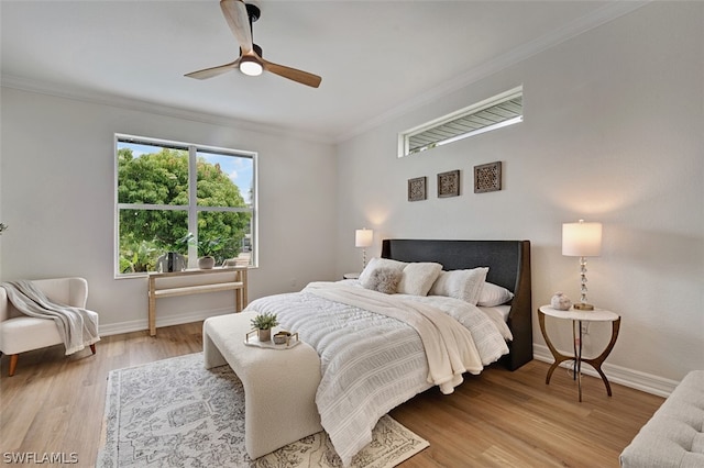 bedroom with ceiling fan, ornamental molding, and light hardwood / wood-style flooring