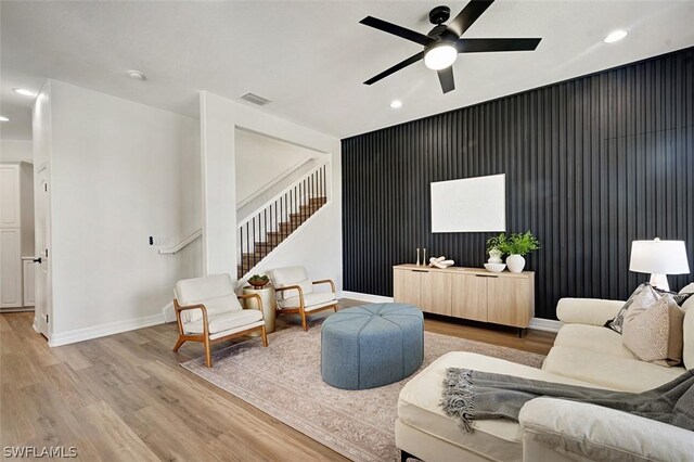 living room with ceiling fan and light hardwood / wood-style floors