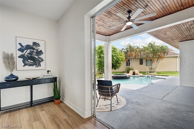 view of swimming pool featuring ceiling fan, an in ground hot tub, and a patio