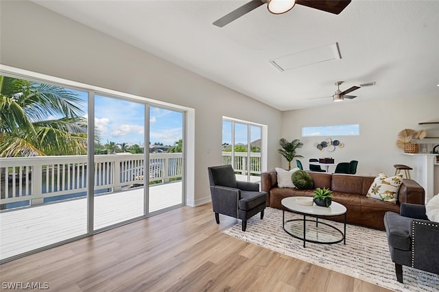 living room with light wood-type flooring and ceiling fan