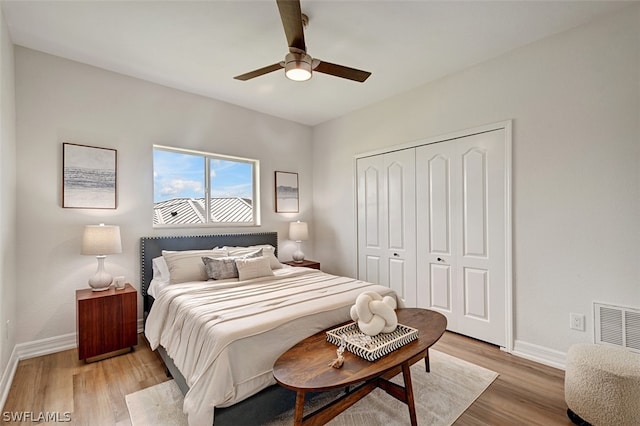 bedroom featuring light wood-type flooring, a closet, and ceiling fan