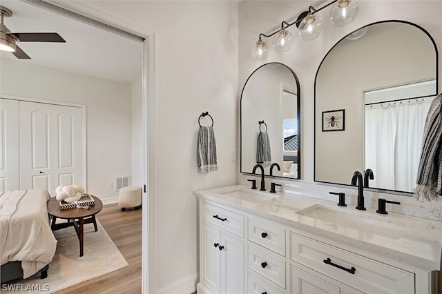 bathroom with ceiling fan, hardwood / wood-style floors, and vanity